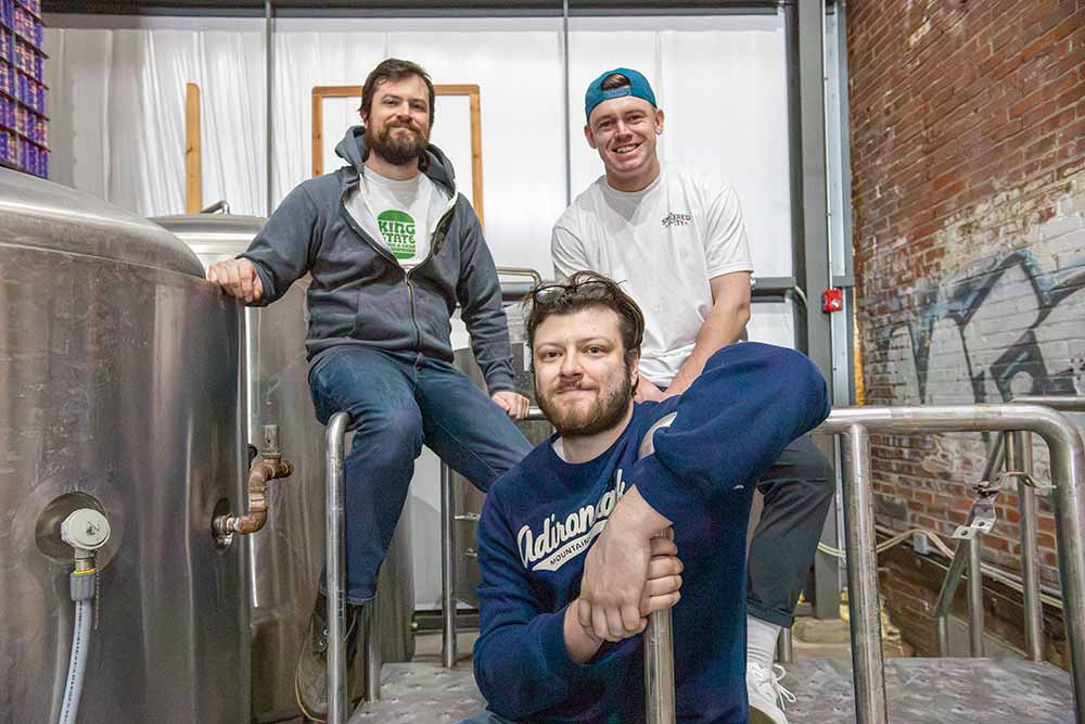 smoldered society co-founders and brand director, cameron frank, head brewer, ryan zacarchuk, and art director and director of sales and marketing, peter cahlstadt